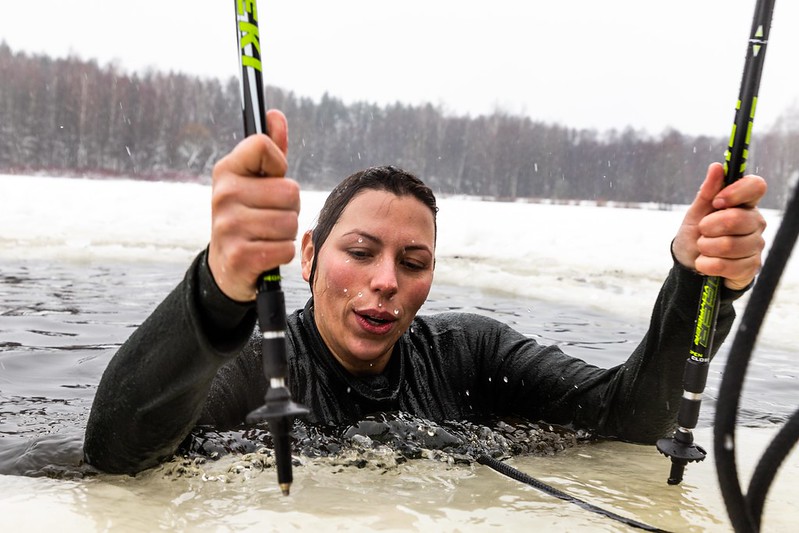 The Risks of Cold Plunge - woman clinging on boat after ice bathe