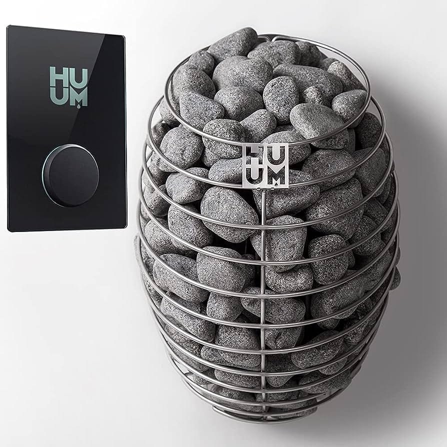 The HUUM Drop heater beside its wall control panel
