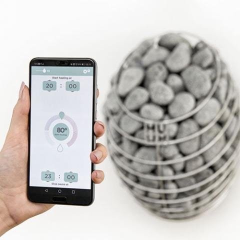 The HUUM app on a phone beside the Drop heater