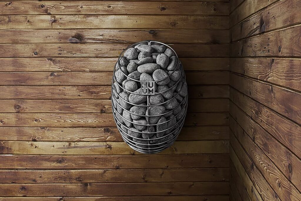 HUUM Drop mounted on a dark timber sauna wall