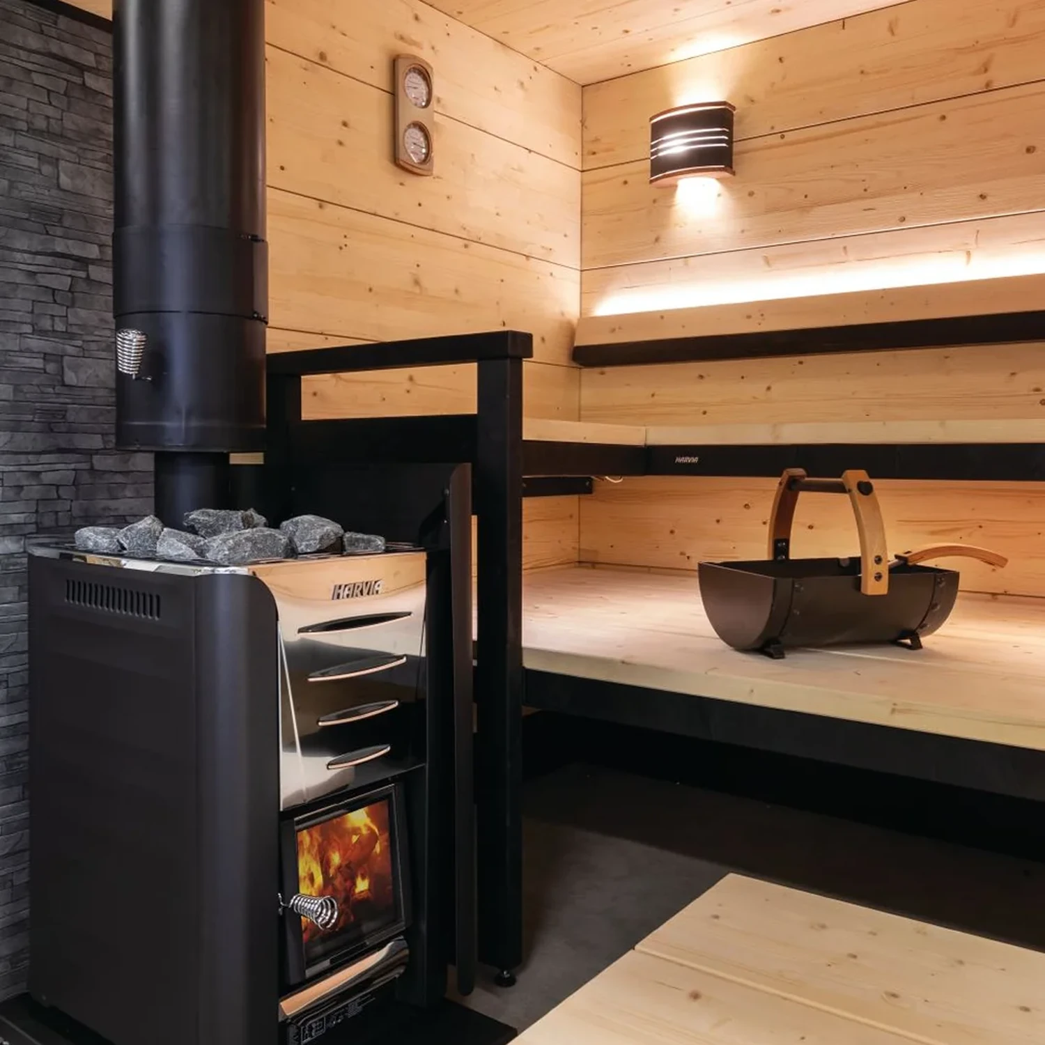 Harvia wood burning heater in a dark timber sauna