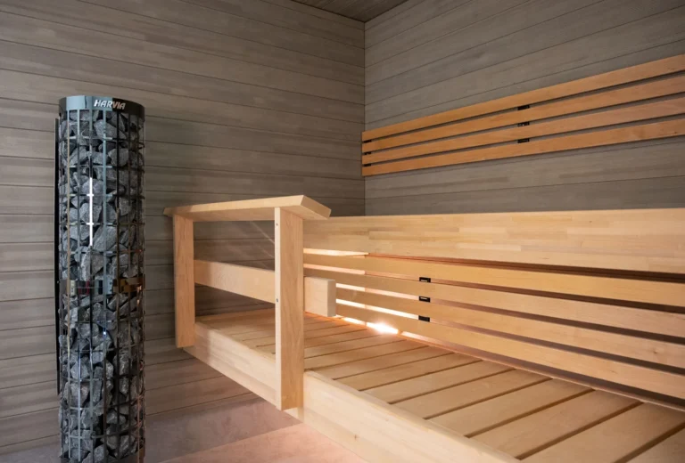 Harvia Cilindro PC66E black steel pillar heater installed in a sauna
