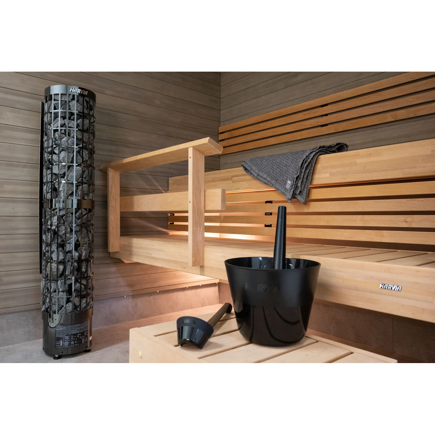 Harvia Cilindro PC66E black steel heater in a timber lined sauna