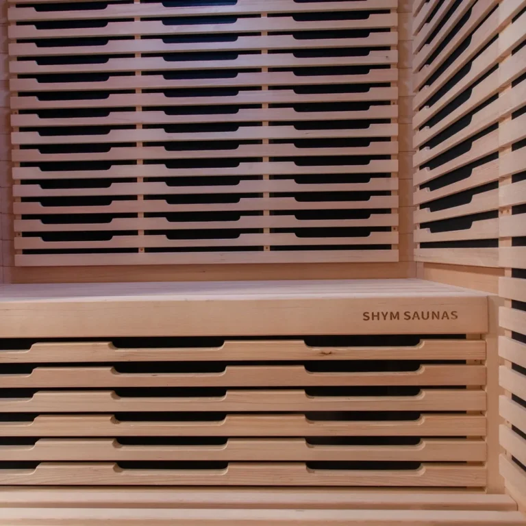 Hemlock bench with engraved SHYM Saunas branding inside the Aura infrared sauna