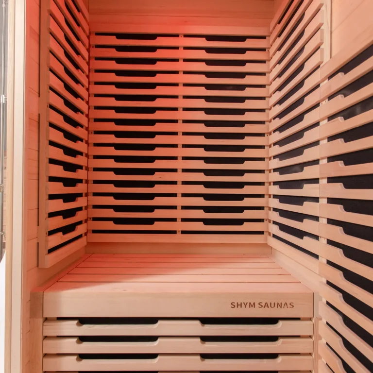 Hemlock bench with SHYM Saunas branding inside the Aura Infrared Sauna