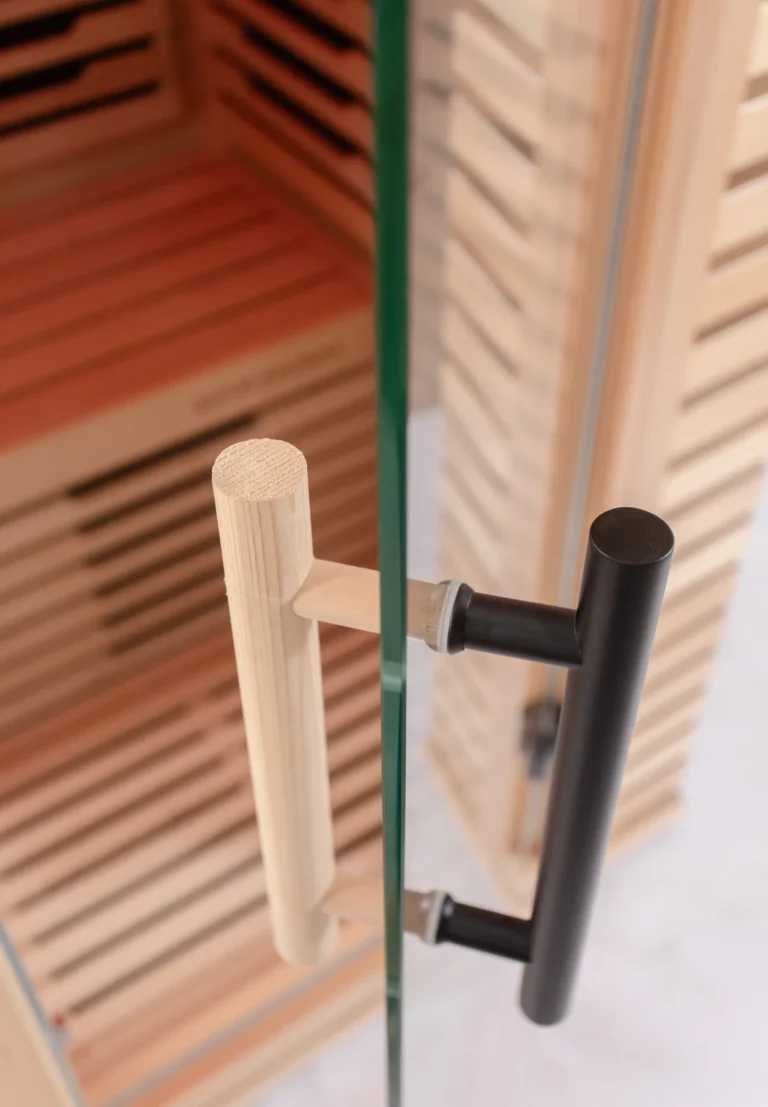 Tempered glass door handles on the Aura Infrared Sauna, close up