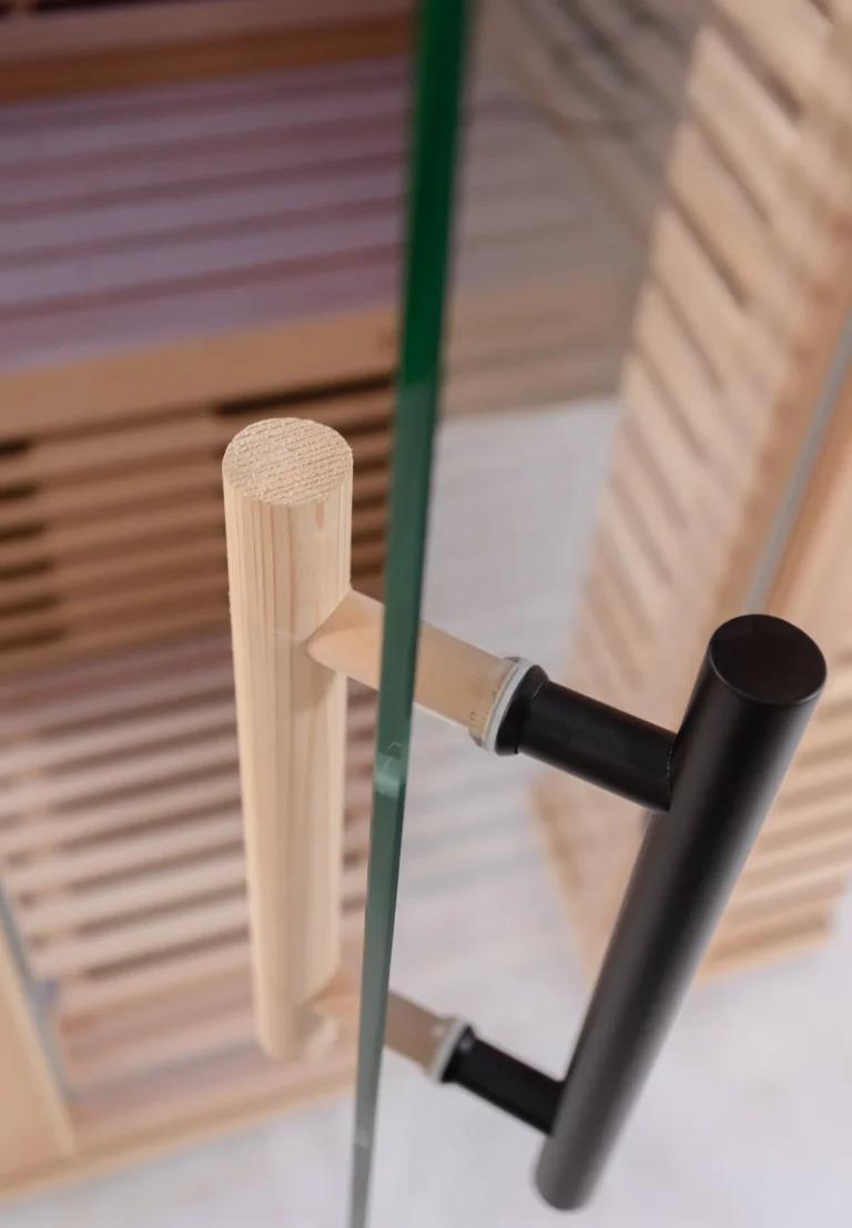 Tempered glass door handles on the Aura Infrared Sauna, close up
