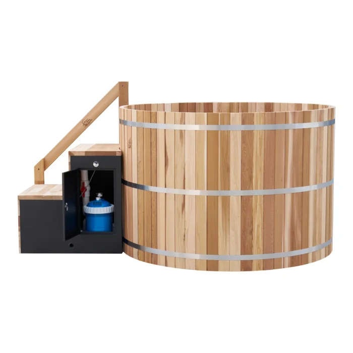 Equipment cabinet open beside the cedar hot tub showing the filtration system