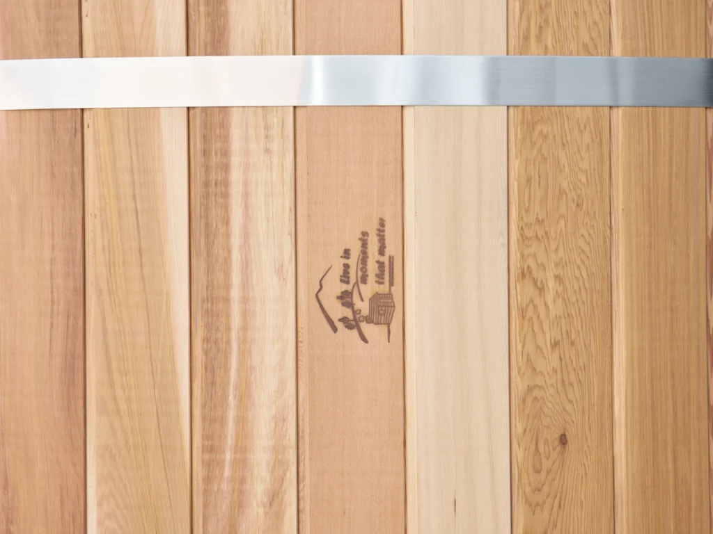Close up of the western red cedar staves and the Shym Saunas brand mark