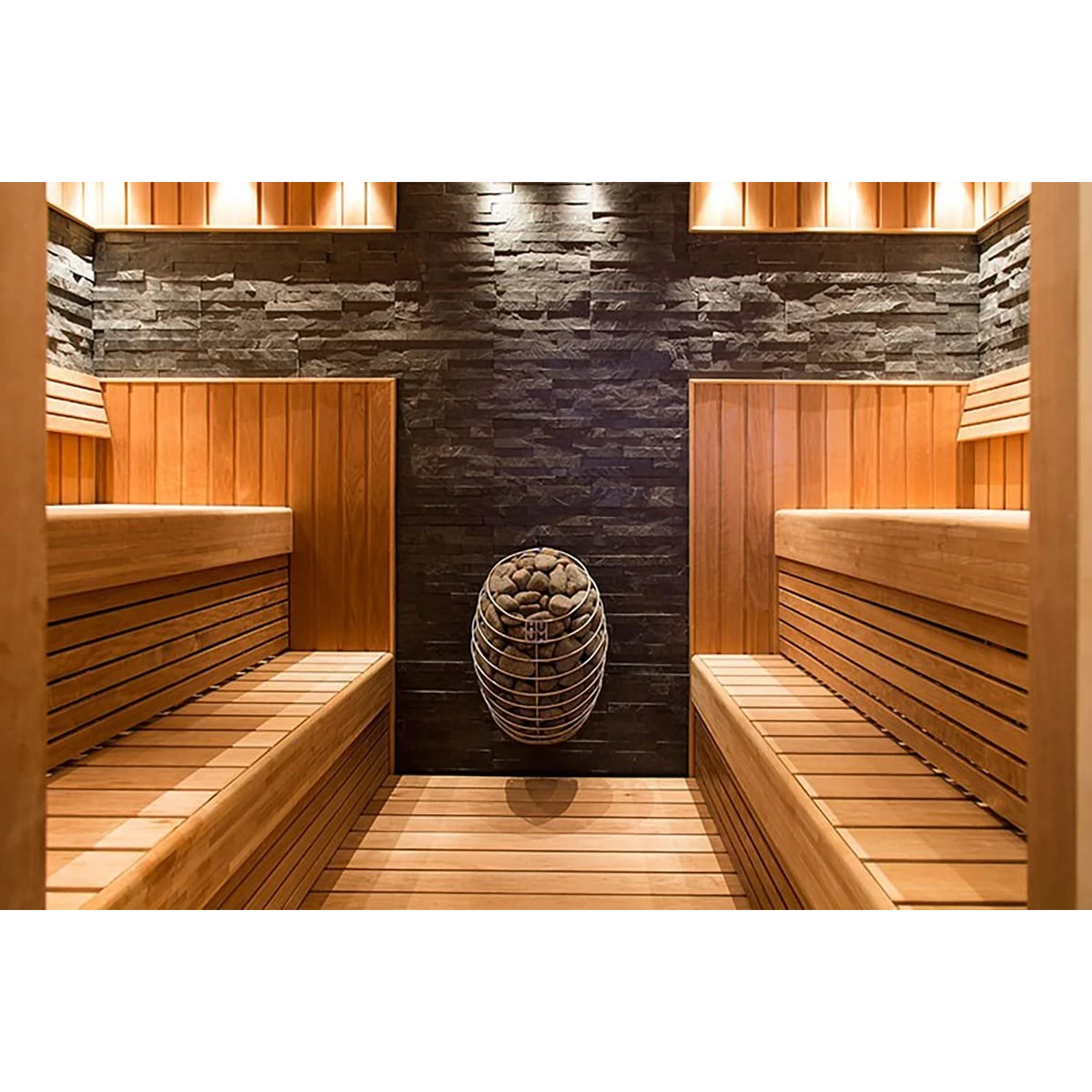 HUUM DROP heater on the end wall of a sauna with long timber benches