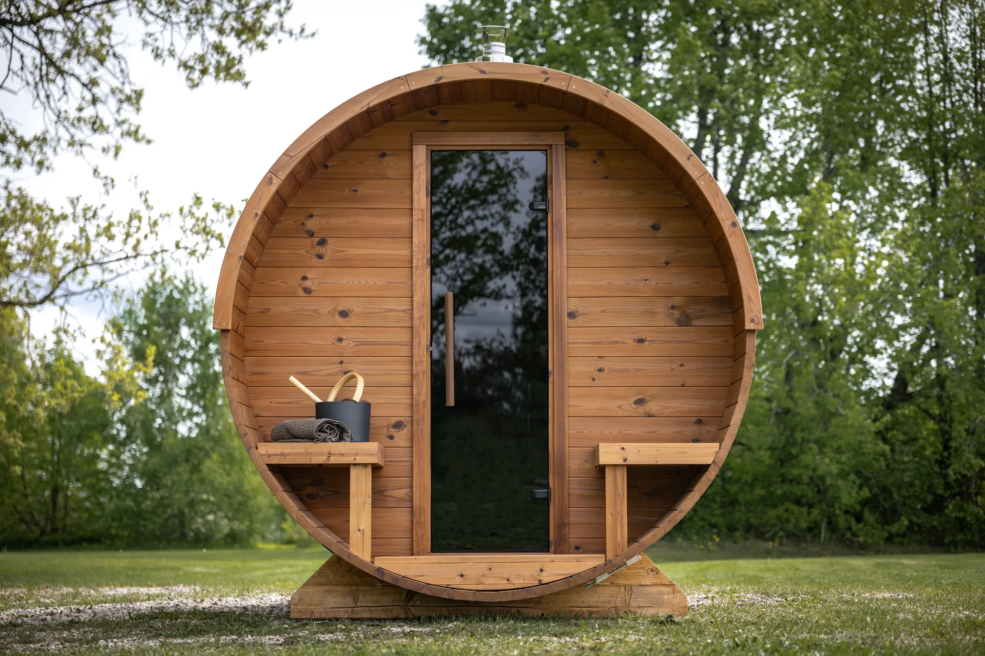 Lerra Plus barrel sauna with porch in a garden, an example of a home sauna in Australia
