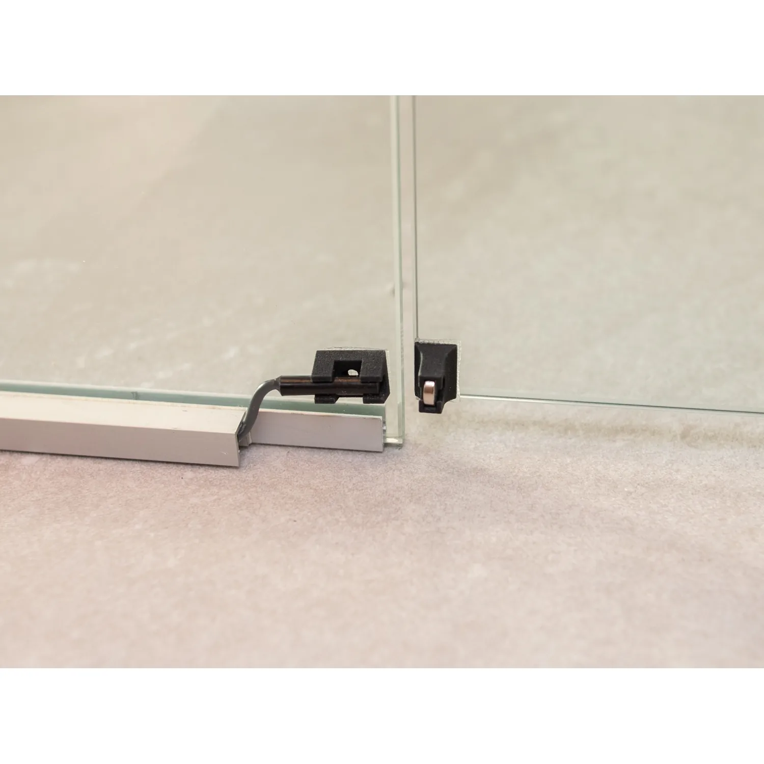 Harvia door sensor fitted at the base of a glass sauna door